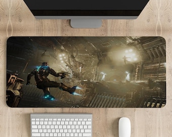 May include: A rectangular gaming mousepad featuring a sci-fi scene with a figure in a spacesuit. The image shows a futuristic interior with a character in action. A keyboard, mouse, and monitor are visible.