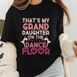 May include: Black t-shirt with pink text that reads "That's my Granddaughter on the Dance Floor" with a pink heart and two pink dancing figures.