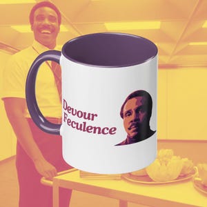 May include: White ceramic mug with a purple rim. The mug features a graphic of a man's face with the text "Devour Feculence" in red and purple.