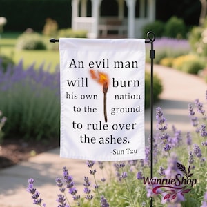 May include: White garden flag with the quote "An evil man will burn his own nation to the ground to rule over the ashes" attributed to Sun Tzu. The flag features a burning torch graphic and is displayed outdoors.