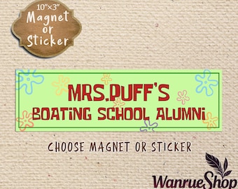 May include: A rectangular magnet or sticker with the text "MRS. DUFF'S BOATING SCHOOL ALUMNI" in red letters on a green background. The magnet measures 10" x 3". The words "Magnet or Sticker" are above the rectangular sign.