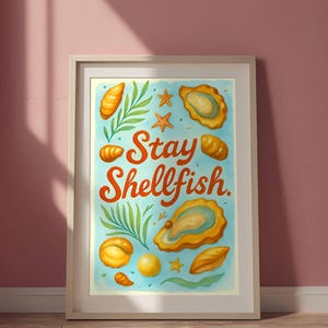 May include: Framed art print with a light blue background featuring illustrations of oysters, starfish, and other sea elements. The words "Stay Shellfish" are written in orange script. The artwork is framed in a white wooden frame.
