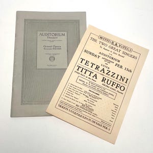 May include: Two vintage programs. One is a light gray booklet for the Auditorium Theatre's Grand Opera Season 1913-1914. The other is a beige flyer advertising a recital by Luisa Tetrazzini and Titta Ruffo at the Auditorium on February 15th.