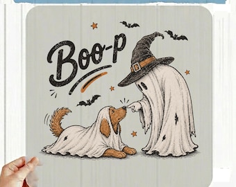 May include: A DTF transfer featuring a brown dog and a ghost both wearing white sheets, with the text Boo-P written in black. The design includes small black bats and orange stars scattered around the figures on a light gray background.