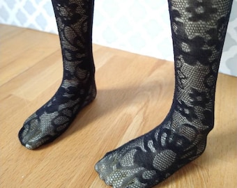 May include: Black lace tights with a floral pattern.