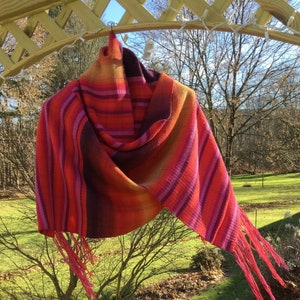 Handwoven shawl in merino wool sunset colors red orange purple pink yellow scarf