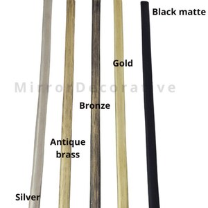May include: A range of decorative mirror frames in finishes such as silver, antique brass, bronze, gold, and black matte. The word "Frames" is at the bottom, and "Mirror Decorative" is at the top of the image.