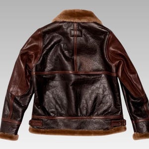 Front view of sheepskin leather jacket with soft faux shearling lining, zip closure, and timeless winter fashion design.