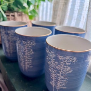 May include: A set of three ceramic nesting bowls in shades of blue, green, and white. The bowls have a speckled glaze and a simple design. The largest bowl is about 18 cm in diameter.