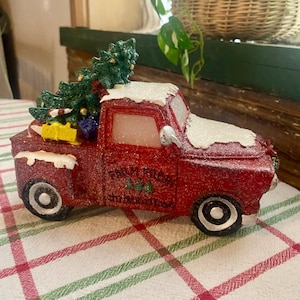 Snow Covered Red Truck with Christmas Tree decor