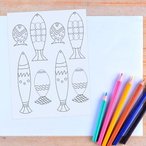 May include: A printable sheet with black and white outlines of fish with different patterns. The fish are ready to be colored in with crayons or colored pencils.
