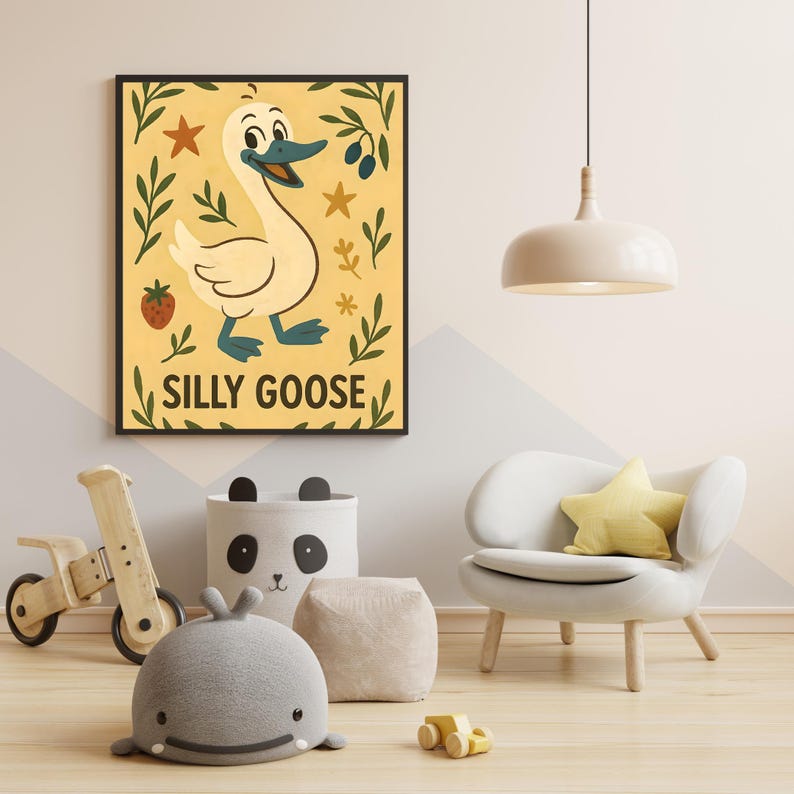 May include: A framed art print with a cartoon goose illustration and the text "SILLY GOOSE". The artwork is in a child's room, alongside a wooden toy, a panda-themed storage bin, and a gray whale-shaped pillow.