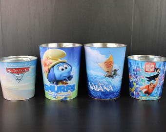 Diversos cubos metálicos para palomitas de maíz de cine de Disney.