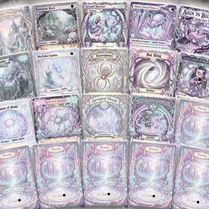 May include: A collection of fantasy-themed trading cards with intricate illustrations in shades of purple, blue, and white. The cards feature various creatures, landscapes, and spells, with text labels and decorative borders. The cards are arranged in a visually appealing layout.