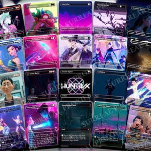May include: A collection of fantasy art cards with various illustrations. The cards feature characters, landscapes, and abstract designs in vibrant colors. Some cards have text, including the word "HUNTRIX" and the phrase "SURREAL PROXIES".