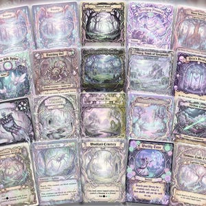 May include: A collection of fantasy-themed trading cards with intricate illustrations. The cards feature various landscapes, creatures, and spells in a soft, pastel color palette. Text on the cards includes titles like "Swamp," "Tainted Wood," and "Twin-Silk Spider."