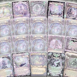 May include: A collection of fantasy-themed trading cards with intricate illustrations in shades of purple, green, and white. The cards feature various creatures, landscapes, and spells, with text labels and decorative borders. The cards are arranged in a grid.
