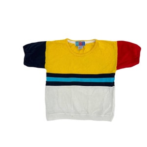 May include: A yellow, red, blue, and white striped short-sleeved shirt with a crew neck.