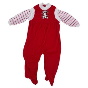 Op de afbeelding: Rode voetjumpsuit met wit en rood gestreepte mouwen. De jumpsuit heeft een witte kraag en een afbeelding van een Dalmatische hond met kerstverlichting. De jumpsuit is ontworpen voor kinderen.
