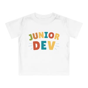 May include: White baby onesie with the text "JUNIOR DEV" in colorful letters. The letters are outlined in white and have a retro, playful style.