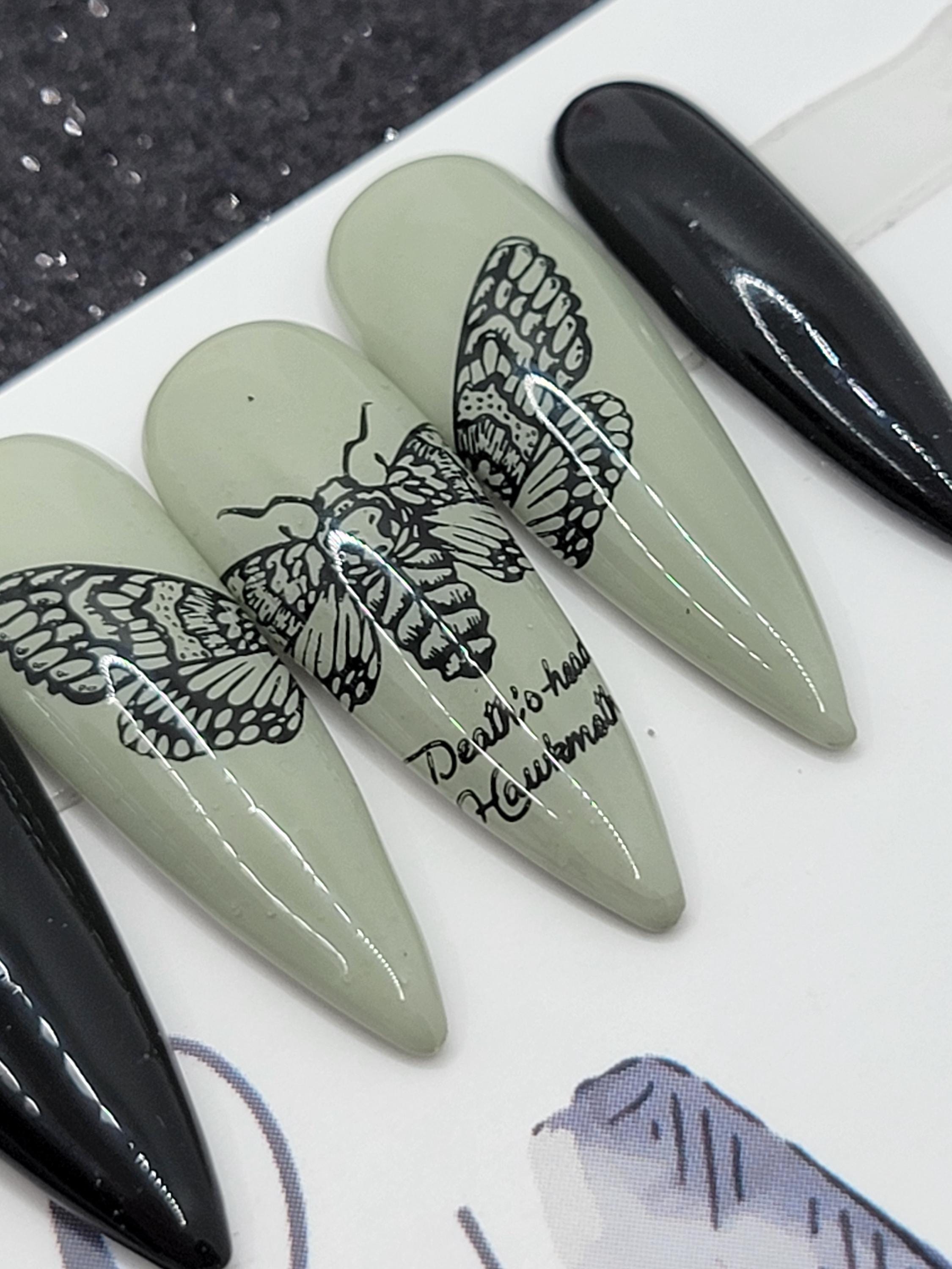 Edgy Black Faux Moth Nail Design