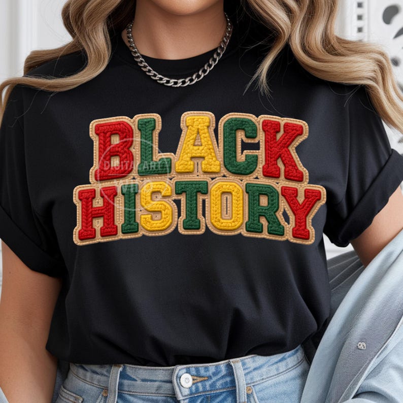May include: Black t-shirt with the words "BLACK HISTORY" in red, green, and yellow, with a textured, stitched appearance. The text is outlined in a brown color. The shirt has rolled-up sleeves.