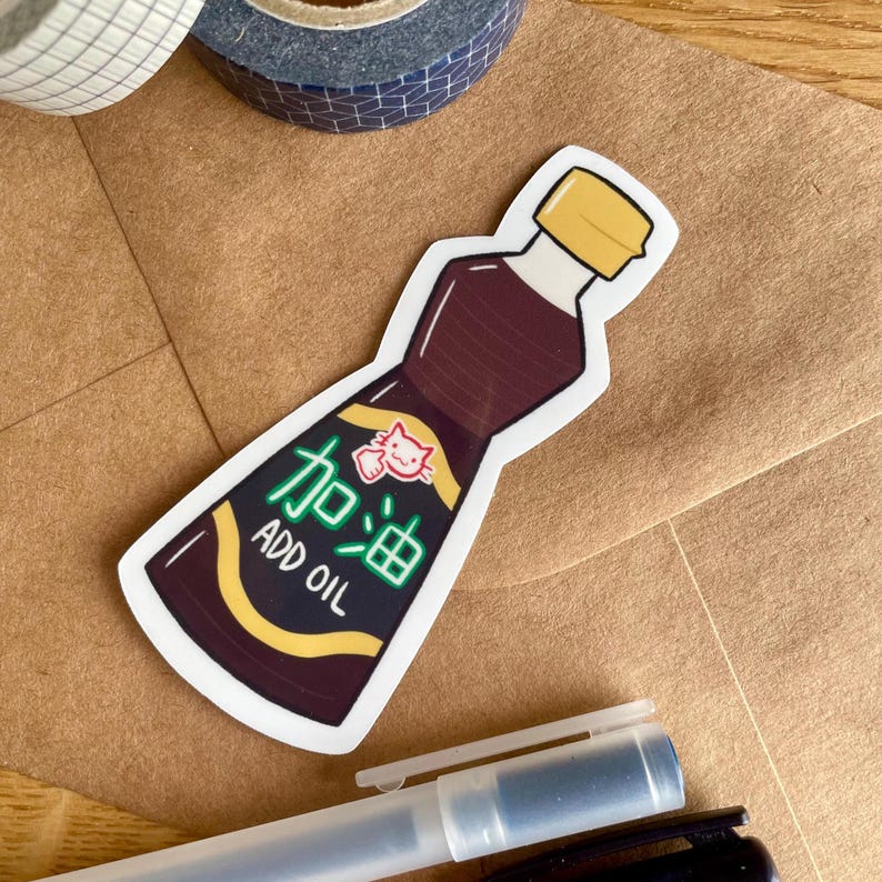May include: A sticker of a brown bottle with a yellow lid. The bottle has the text "Add Oil" and Chinese characters that translate to "Add Oil".