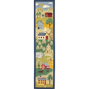 May include: A needlepoint tapestry with a blue border, showing a rural scene. It features a red barn, houses, trees, and a church with a white steeple. A horse and dog are in the foreground. The color scheme includes blues, greens, yellows, and reds.