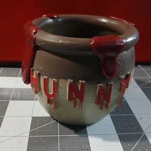 May include: A set of three ceramic mugs with a speckled, matte finish. The mugs are in shades of cream, light gray, and dark gray. Each mug has a simple, minimalist design, perfect for coffee or tea.