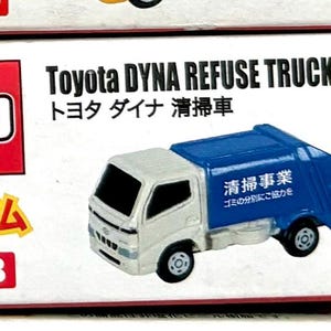 May include: A miniature Toyota Dyna Refuse Truck toy. The truck has a white cab and a blue refuse container. Text on the box includes "Toyota DYNA REFUSE TRUCK" and Japanese characters. The box also has the number "45-B".