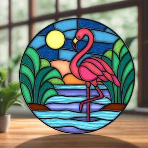 May include: A stained glass window depicting a pink flamingo standing in water. The background features a sunset, a yellow sun, and blue sky. Green foliage surrounds the flamingo, all within a circular frame.