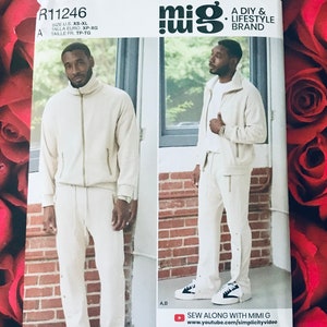 May include: Simplicity sewing pattern R11246 featuring a cream-colored tracksuit with a zip-up jacket and drawstring pants. The pattern includes sizes XS-XL. The brand is "mig" and the pattern is designed and printed in the USA.