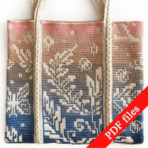 May include: A crochet tote bag with a gradient design in shades of pink, brown, and blue. The bag has a white crocheted strap and features a floral pattern. The text "PDF files" is printed in red on a white background in the lower right corner of the image.