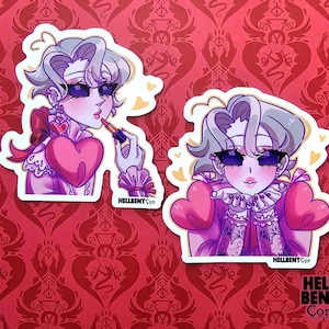 May include: Two stickers featuring a cartoon character with pale skin, purple eye shadow, and gray hair. One sticker shows the character applying lipstick, and the other shows the character with a heart-shaped chest piece. The stickers are on a red background.