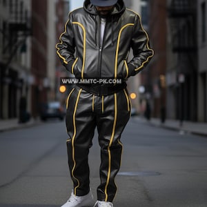 May include: Black leather tracksuit with yellow trim. The jacket has a hood and a zipper closure. The pants have a matching yellow stripe down the sides. The website address www.mmtc-pk.com is visible on the jacket.