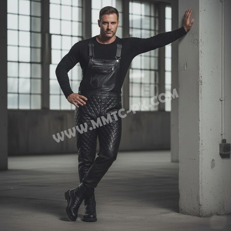 May include: Black leather overalls with a quilted pattern. The overalls have suspender straps and a chest pocket. The model is wearing a black long-sleeve shirt and black boots. The website address www.mmtc-pk.com is visible.