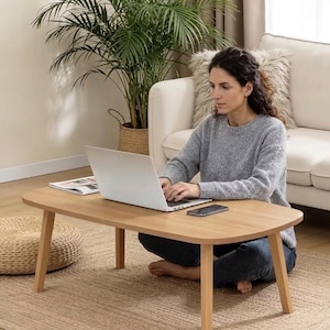 May include: A white ceramic mug with a black handle and the text "But First, Coffee" in a handwritten style. The mug is on a white surface. The mug is approximately 4 inches tall.