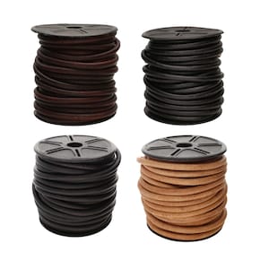 May include: Four spools of leather cord in shades of brown, black, and tan. Each spool is wound tightly and sits on a black plastic base. The cords are of a consistent thickness, ideal for crafts or jewellery making.