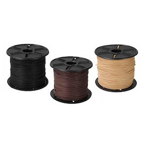 May include: Three spools of cord in black, dark brown, and tan. Each spool is made of black plastic with a circular top and bottom, featuring a central hole and radial spokes. The cord is wrapped tightly around the centre of each spool.