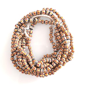 Chevron Trade Beads Glasperlen 7 - 10 mm Gelb und Rot. Verkauft pro 56 cm Strang