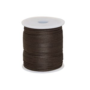 May include: A spool of dark brown cord wrapped tightly around a white plastic cylinder. The cord has a smooth, uniform texture and is wound in multiple horizontal layers from the top to the bottom of the spool, creating a cylindrical shape.