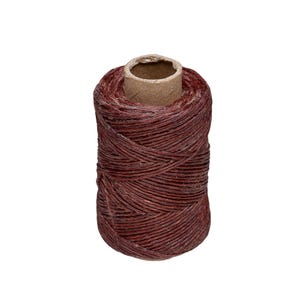 May include: A spool of dark maroon waxed thread wound tightly around a cylindrical cardboard core. The thread has a visible textured finish and is wrapped in a crisscross pattern, showing a deep reddish-brown color throughout the entire spool.
