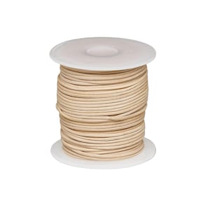May include: A spool of light beige round cord wrapped neatly around a white plastic reel. The cord has a smooth, consistent texture and is wound in multiple layers, filling the space between the two circular white end caps of the spool.