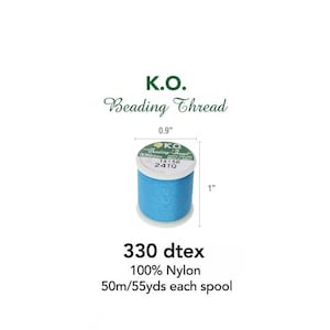 May include: A spool of blue beading thread labeled "K.O. Beading Thread 330 dtex 100% Nylon TX15R 24TQ". The spool is 0.9 inches in diameter and 1 inch in height. The label also states that the spool contains 50 meters or 55 yards of thread.
