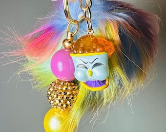 Llavero/dije para bolso esponjoso y colorido de Chip de La Bella y la Bestia con pompón