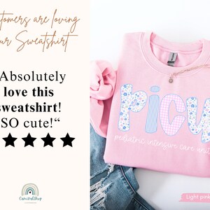 May include: Light pink PICU sweatshirt with floral and gingham letters. The text "pediatric intensive care unit" is below the letters. The image also includes customer reviews and the text "Light pink".