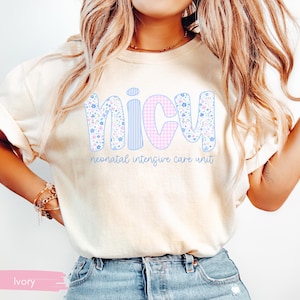 Peut inclure: T-shirt ivoire avec le mot "NICU" en grandes lettres color&eacute;es. Les lettres sont d&eacute;cor&eacute;es de motifs floraux, de rayures et de carreaux vichy. En dessous, le texte "neonatal intensive care unit".