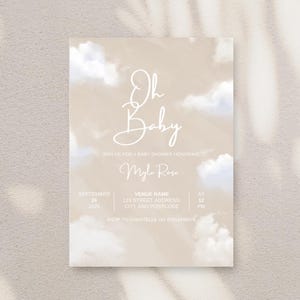 May include: A baby shower invitation with a beige background and cloud-like details. The text "Oh Baby" is in a stylish script, with event details such as date, time, and RSVP information. The invitation is a soft, neutral design.