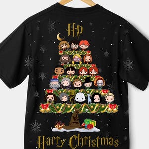 May include: Black t-shirt featuring a Christmas tree design made of cartoon characters. The tree is decorated with gold garland, bells, and a Sorting Hat at the base. The words "Harry Christmas" are printed in gold.