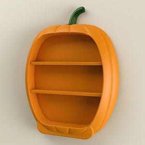 May include: Orange pumpkin-shaped wall shelf with two shelves. The shelf has a green stem and is designed to resemble a pumpkin. Ideal for seasonal decor or a child's room.